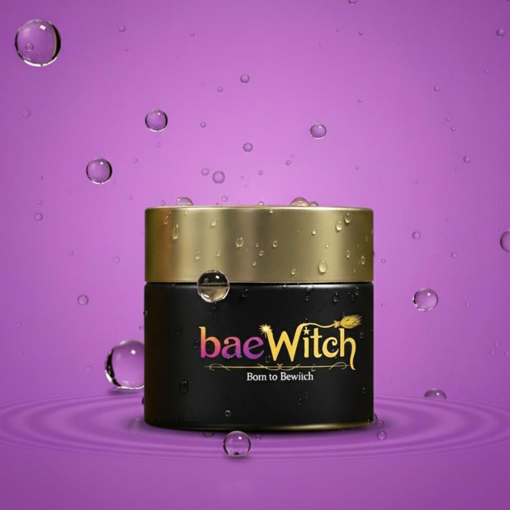 Jar of 'baeWitch' cream on a purple background with water droplets.